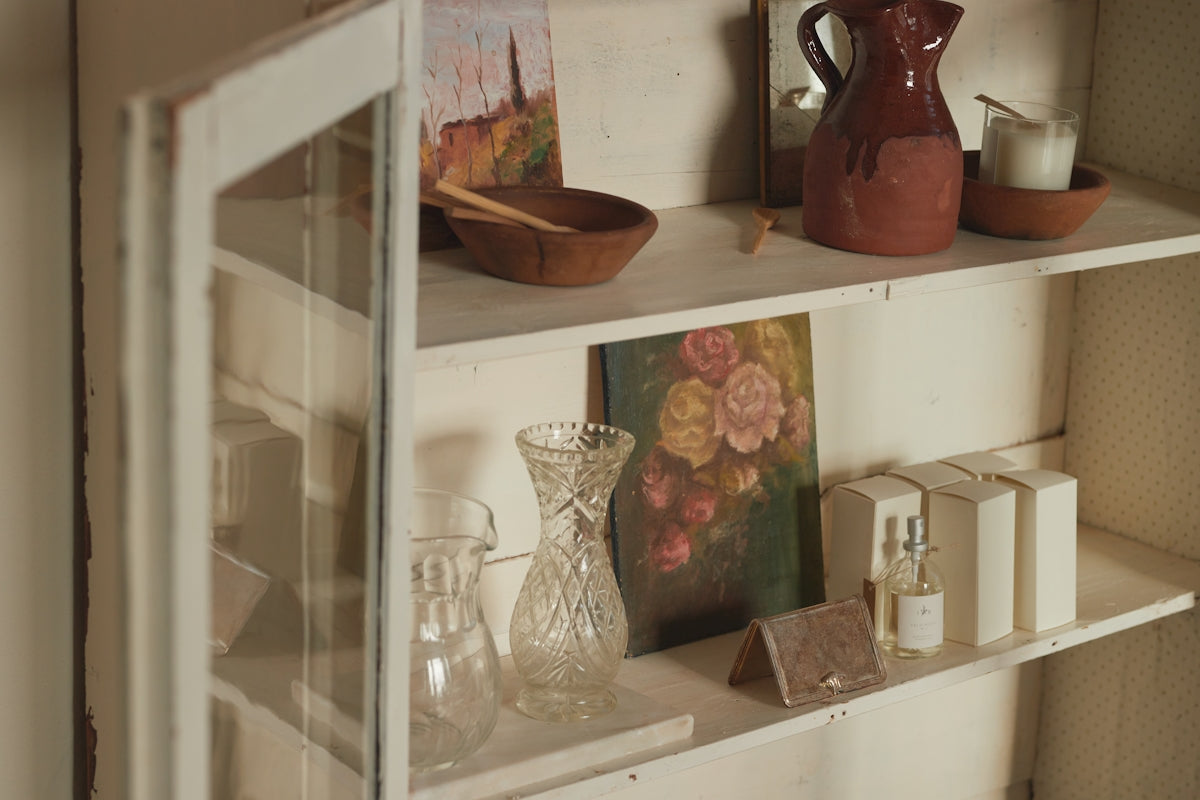 A shelf filled with vases and other items