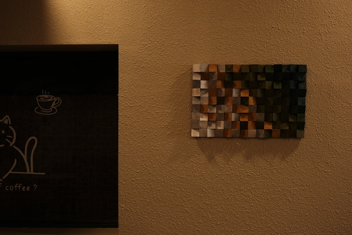 Abstract wooden art piece on a textured wall.